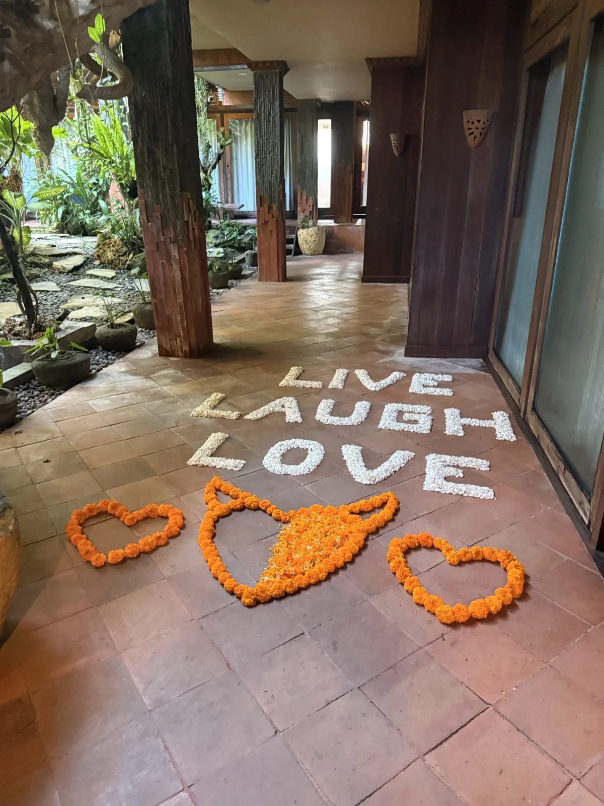 LIVE LAUGH LOVE, spelled out in petals. The real thing asks for more than a slogan.