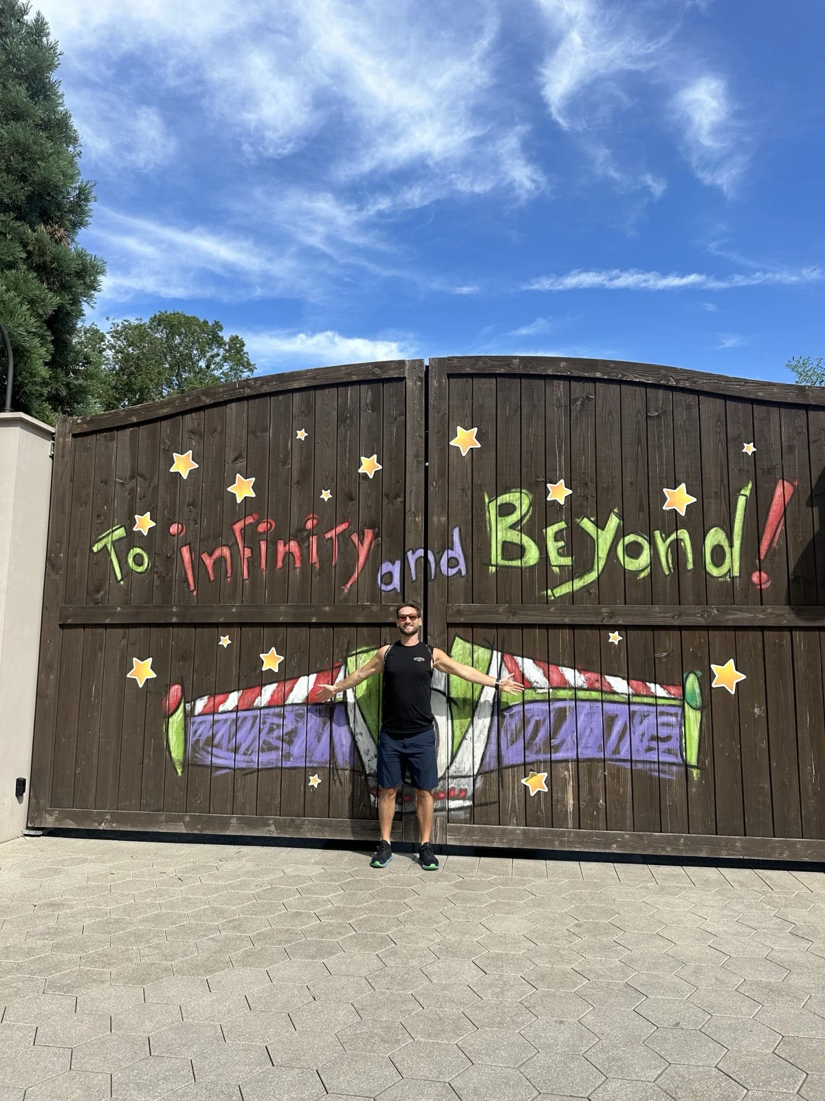 To infinity and beyond. The stories we grew up on quietly shaped how we love. | Zac Spowart at a To Infinity and Beyond Buzz Lightyear mural at Disneyland, illustrating the feel-good trap and Disney love myths, Love Unlocked.