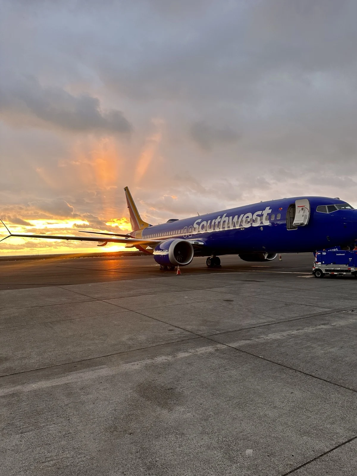 Sunset on the tarmac. The trip starts the moment you decide to protect it. | A plane on the runway at golden hour, illustrating sober air travel and airport tips from Zac Spowart, Nomadic Addictt.